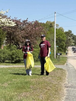 adult and teen girl picking up liter
