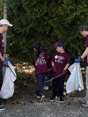 Community volunteers, including children and adults, gather to clean up litter during the Great America Cleanup 2025, supporting Keep North Attleborough Beautiful initiatives. Volunteers participating in the Great America Cleanup 2025, collecting litter along a sidewalk to promote environmental preservation and community pride.